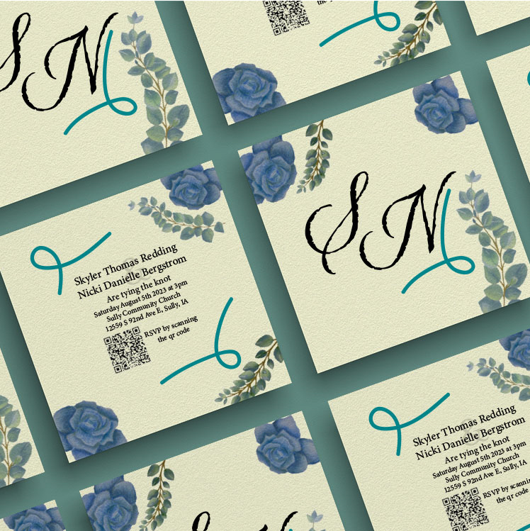 stacks of square invitations with blue roses and sage leaves