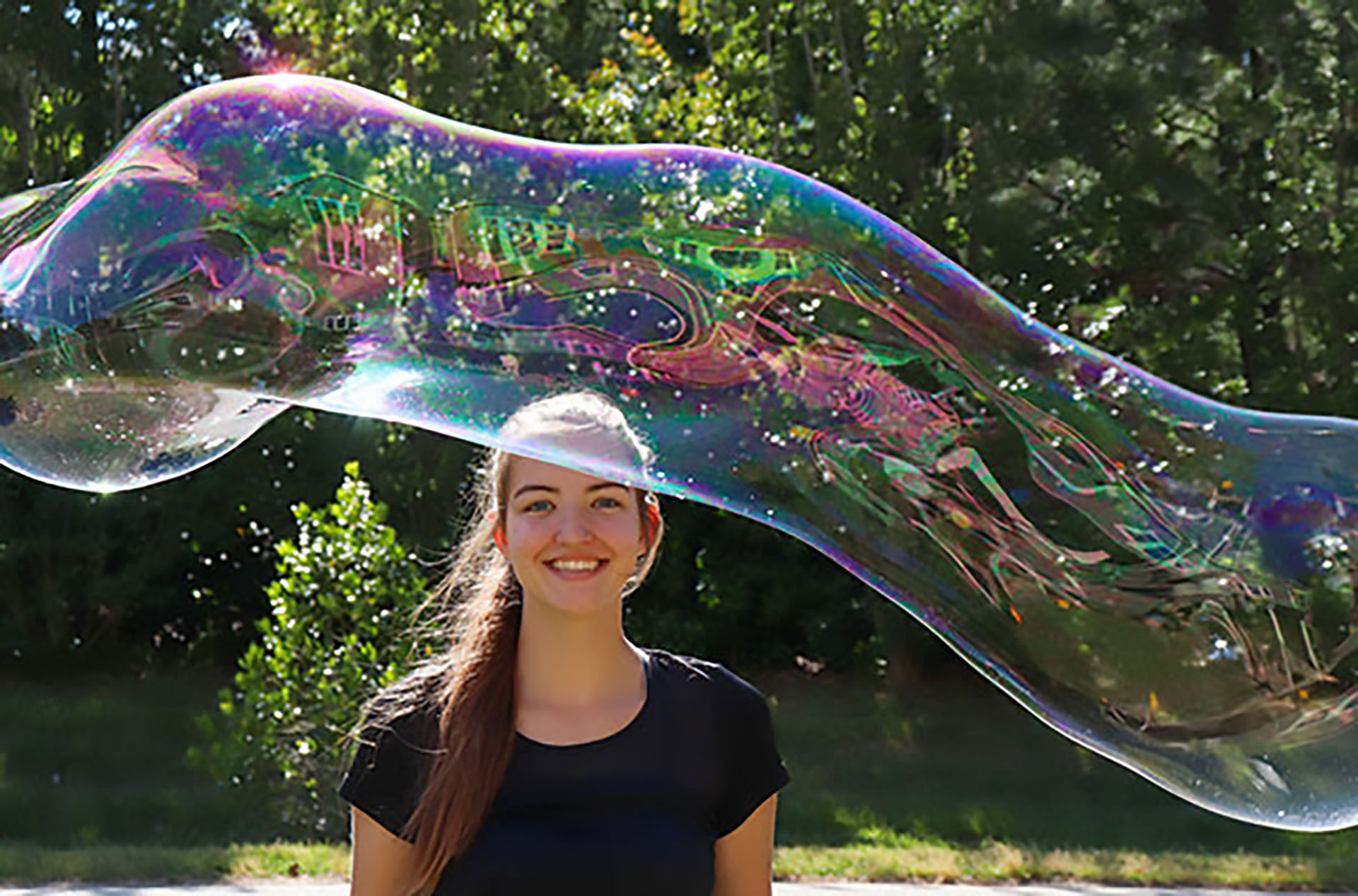 Girl beind a large bubble